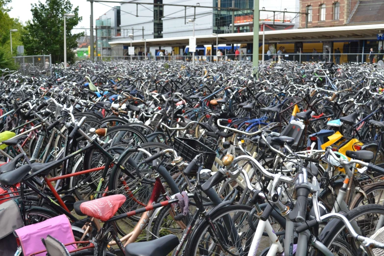 a large amount of bicycles parked in a parking lot