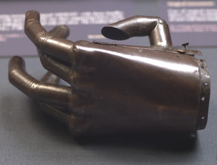 a metal hand made to look like it is sitting on top of a table