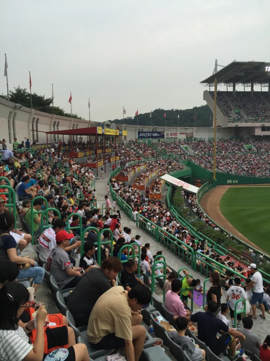 many people in chairs watching a baseball game