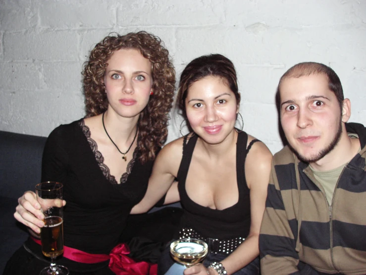 three people holding champagne flutes in their hands