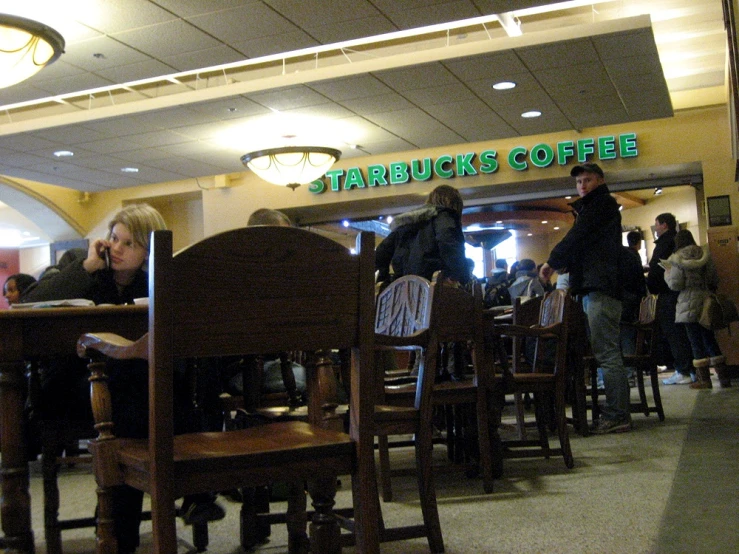 patrons socialize at the starbucks's cafe for breakfast