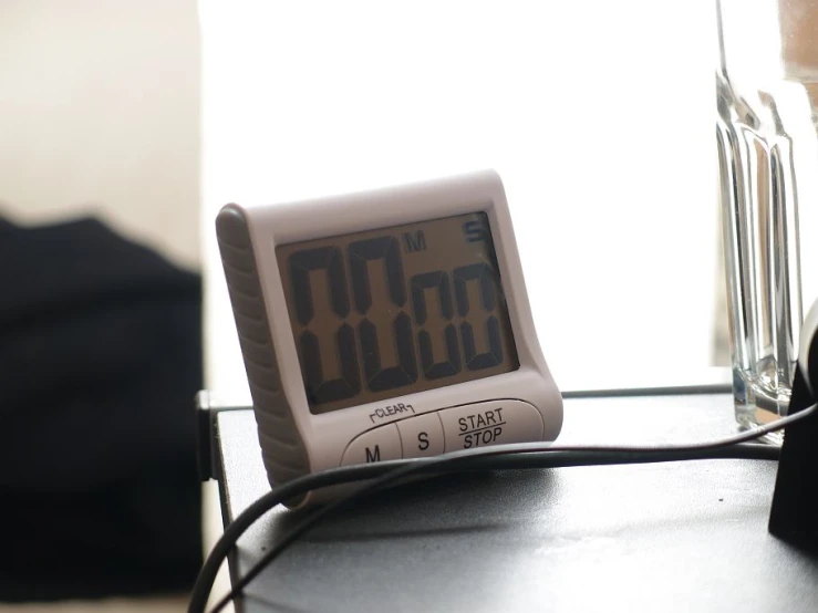 a small clock sitting on top of a table