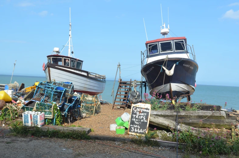 boats resting on the sand at the beach