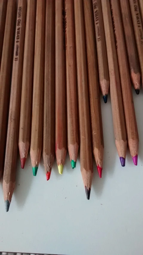 pencils lined up against the side of a desk