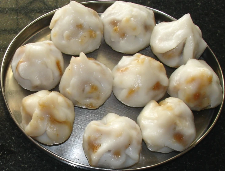 small dumplings that are on a metal pan