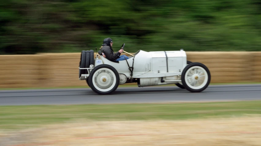 an old timey car rides on a track