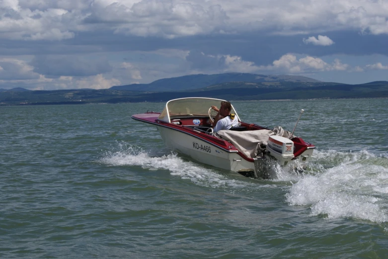 a motorboat rides through the water with people in it