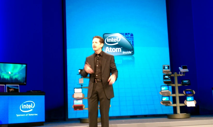 a man standing in front of a intel stage