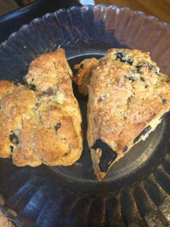 three scones are sitting on a black pan