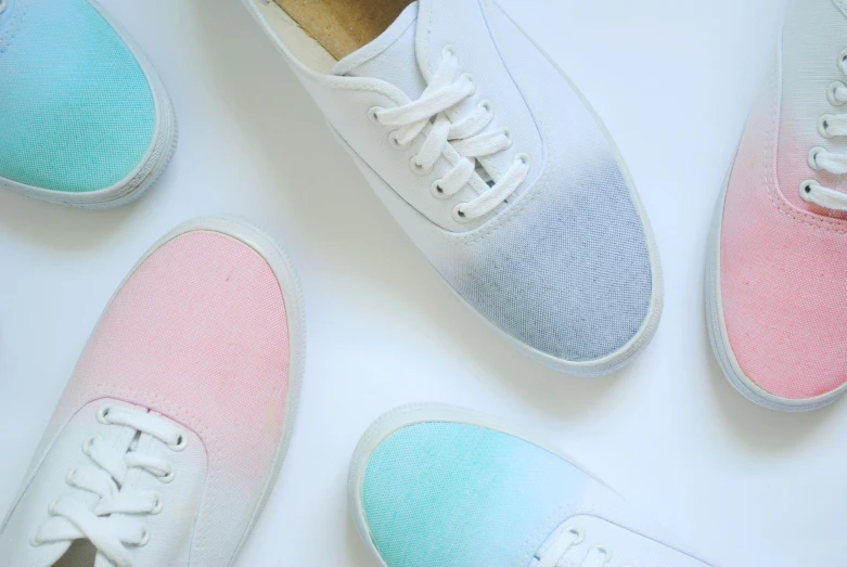 four shoes sitting side by side with colorful stripes