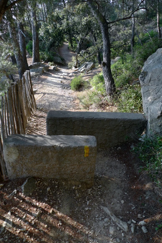 a bench that has been built on a dirt path