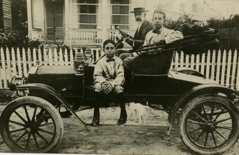 an old pograph of two men driving a horse drawn buggy