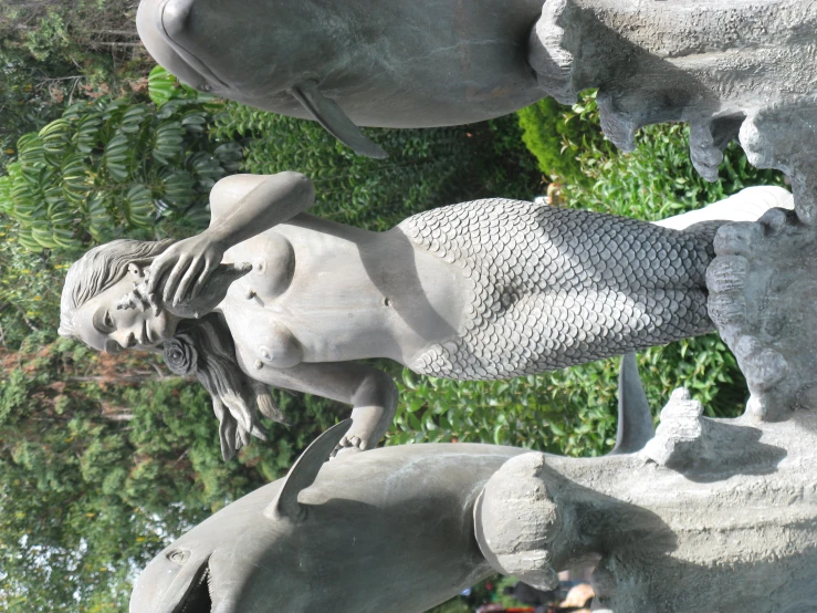 a statue of a woman holding a bird and looking at her face