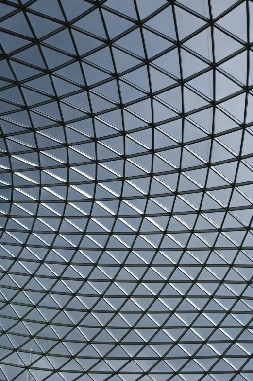 the ceiling inside the large building with the sky in the background