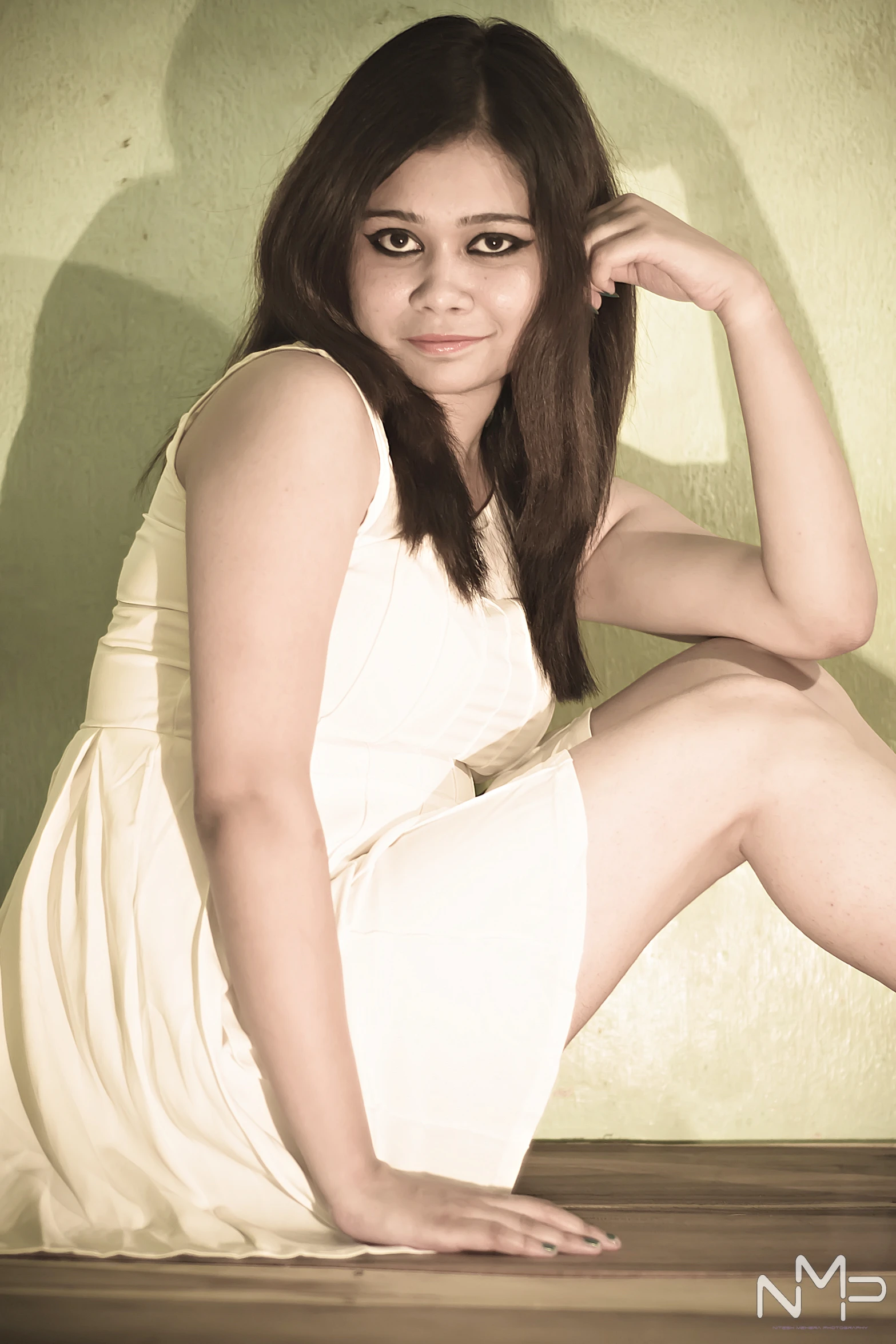 a woman in a white dress posing on a brown counter