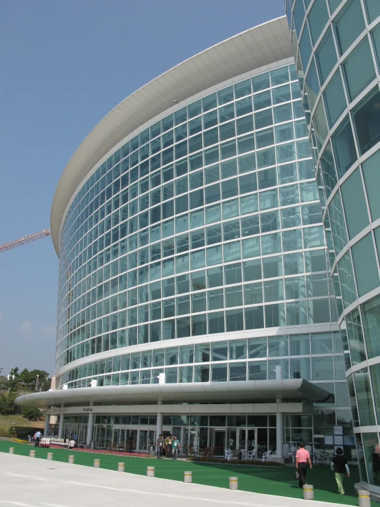 a woman walks past a glass office building