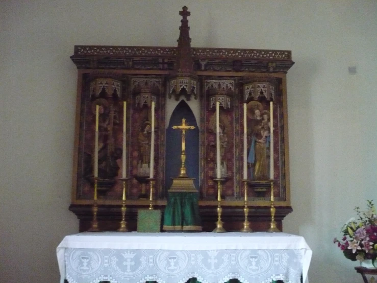 a large wooden church shrine on display in a building