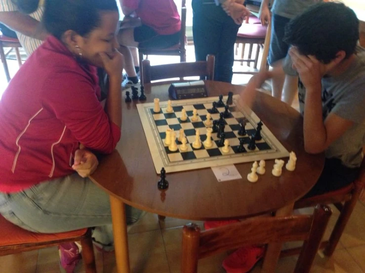 s playing a game of chess on a table