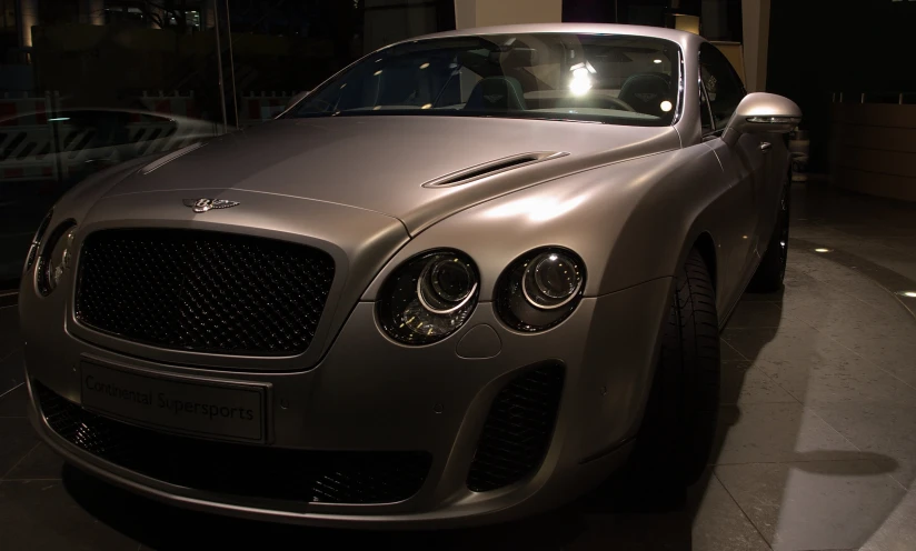 a silver car parked outside of a building