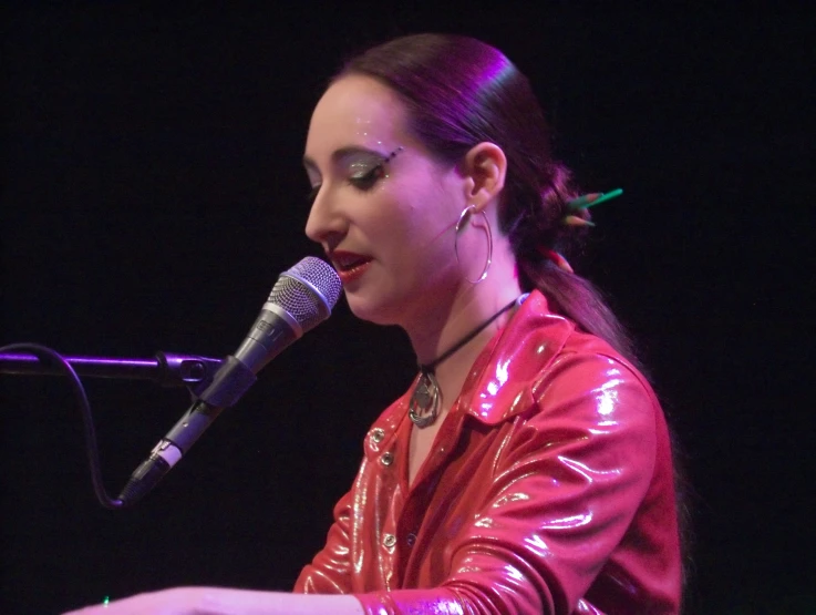 a girl with a red shirt and some headphones and a microphone