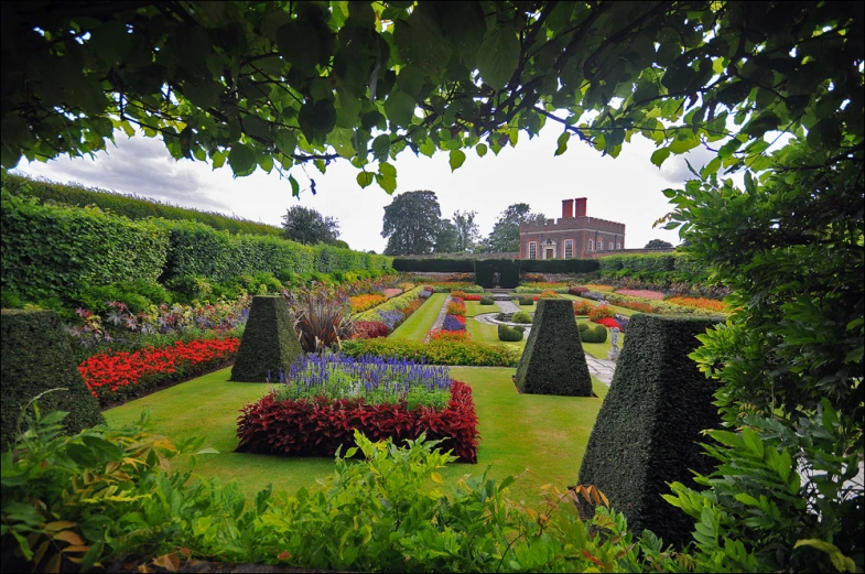 formal garden area with green lawn and topiary