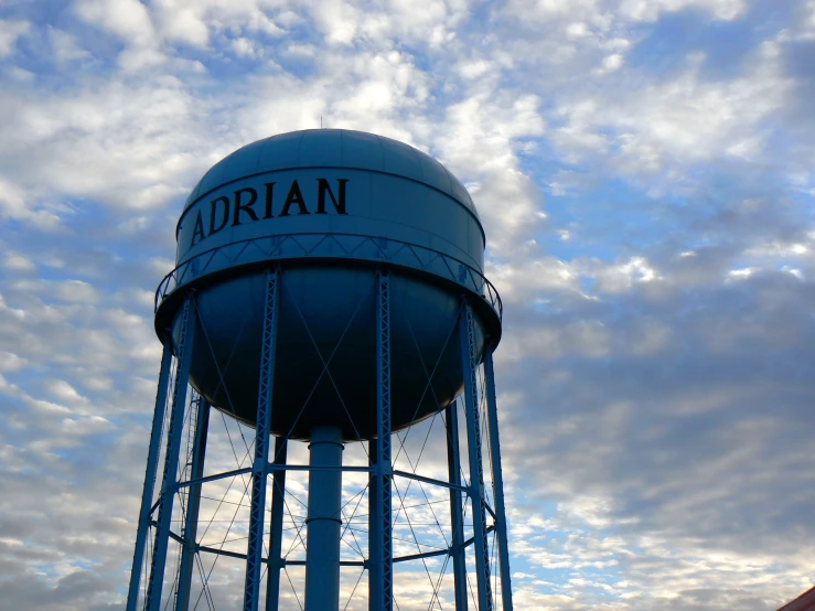 a large water tower sitting underneath cloudy skies