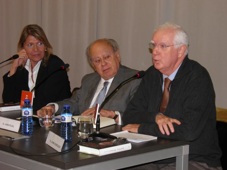 the men are seated at the table for a panel