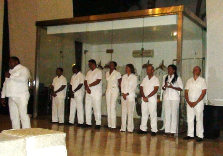 people in white standing on a wooden floor