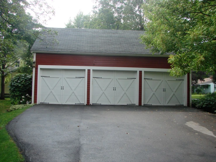 a garage with a two story building behind it