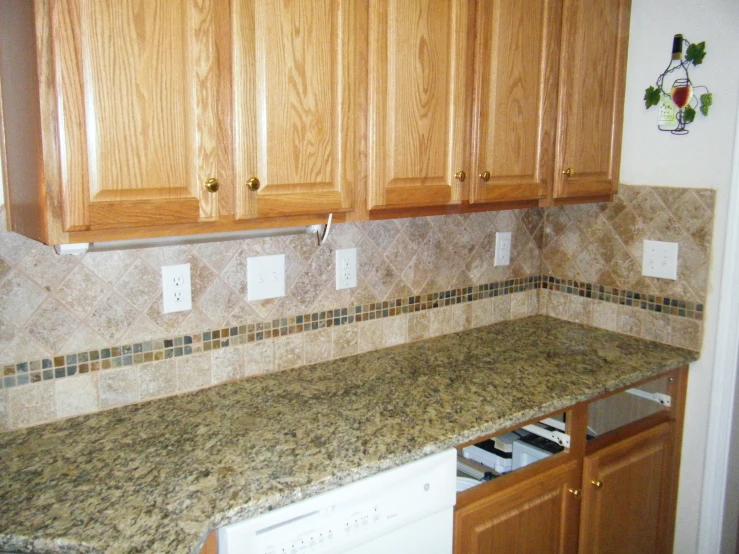 a kitchen counter that has brown cabinets and a white stove
