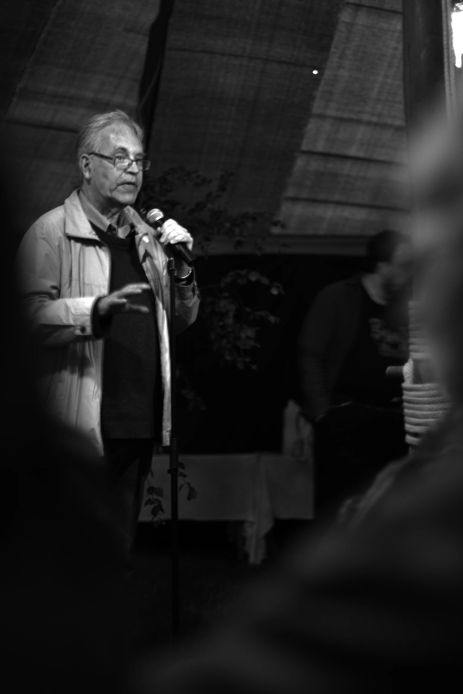 black and white po of an old man with a microphone