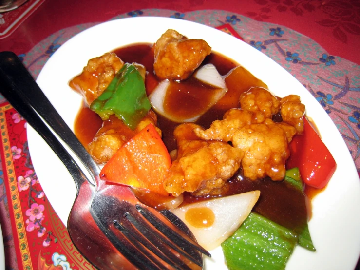 plate full of stew with fork next to plate