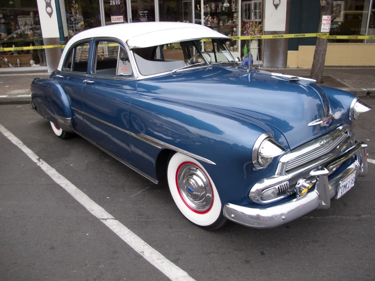 a classic car parked on the side of the road