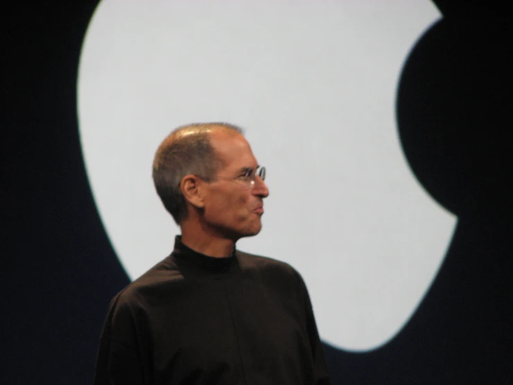 a close up of a person in front of an apple logo