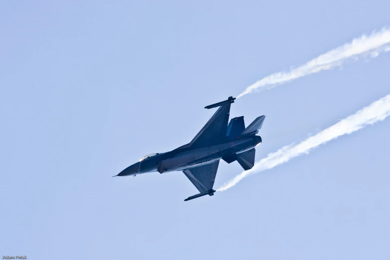 an airplane is flying in the blue sky