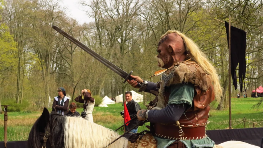 two men dressed up in costumes on horseback