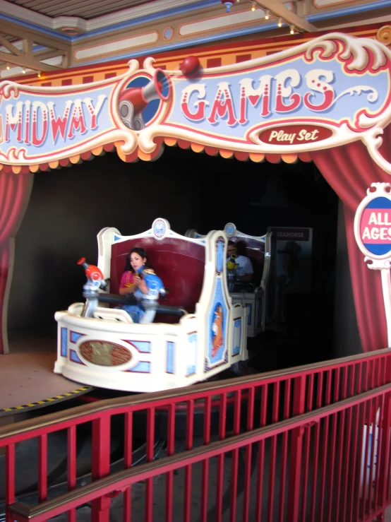 a carnival ride set up inside a room with red fencing