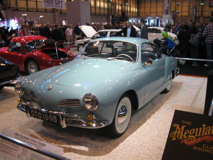 some classic cars on display in a building