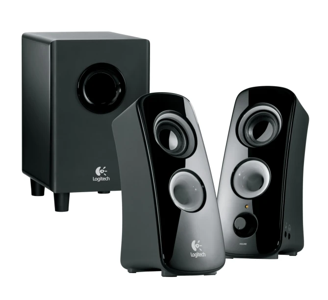 two black computer speakers with one speaker on the back