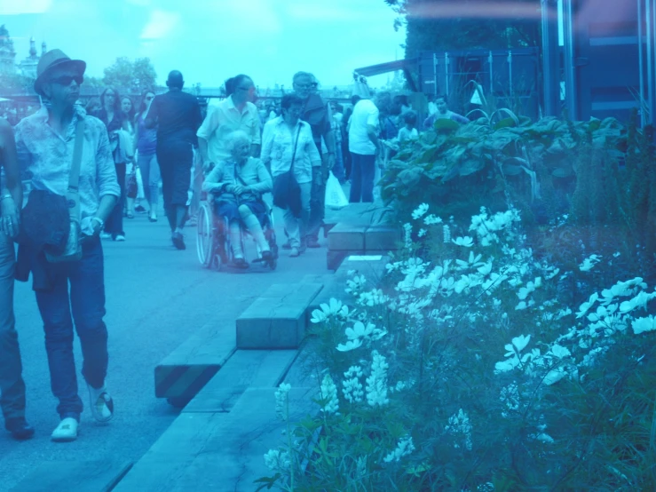 a crowd of people walking down the street