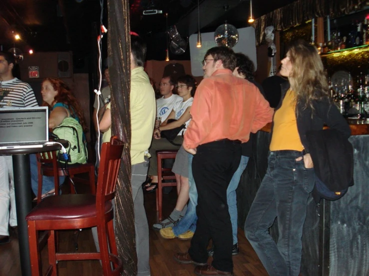 people standing around at a bar and the bars