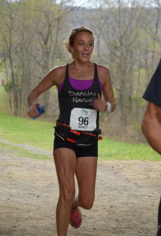 a woman running on a dirt road