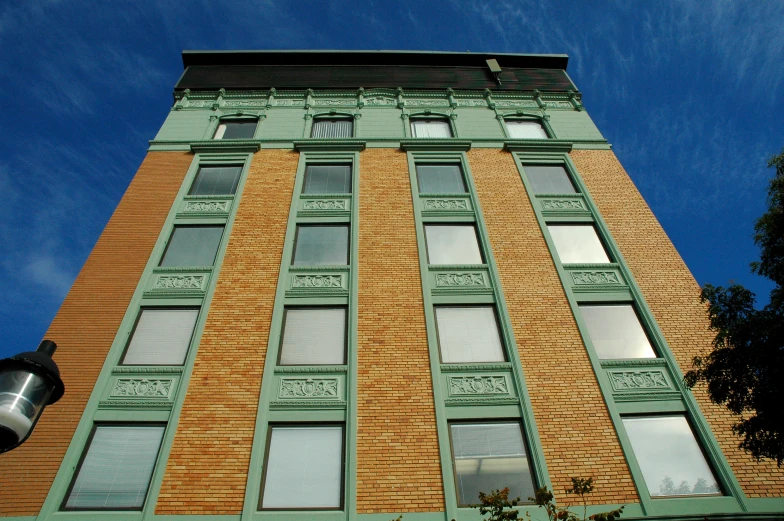 a tall green building with lots of windows