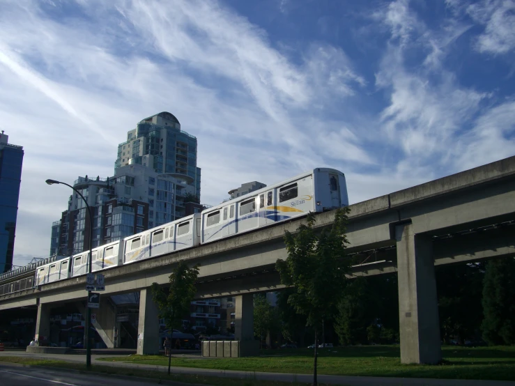 a train travels over a bridge with trees