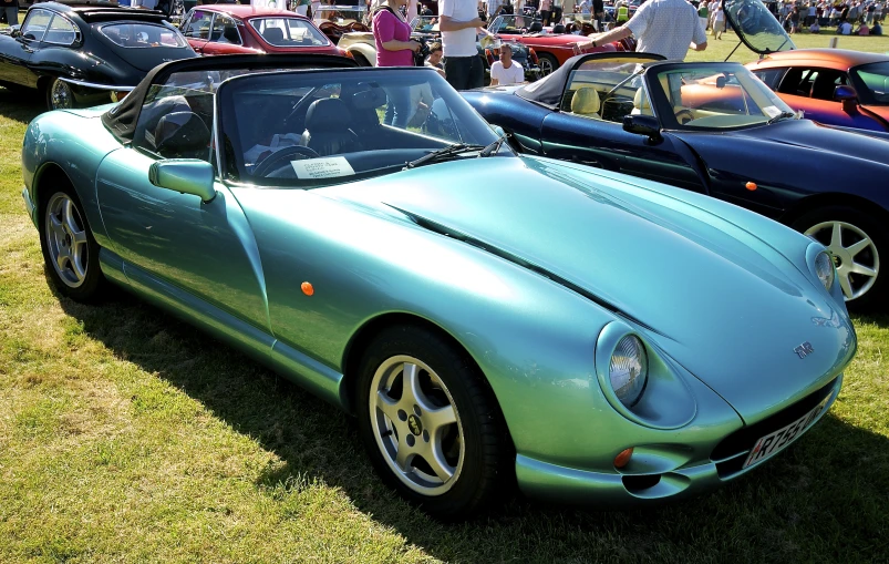 an old style sports car on display at a show