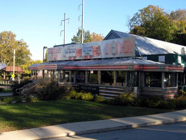 the front of a house with a large sign on top of it