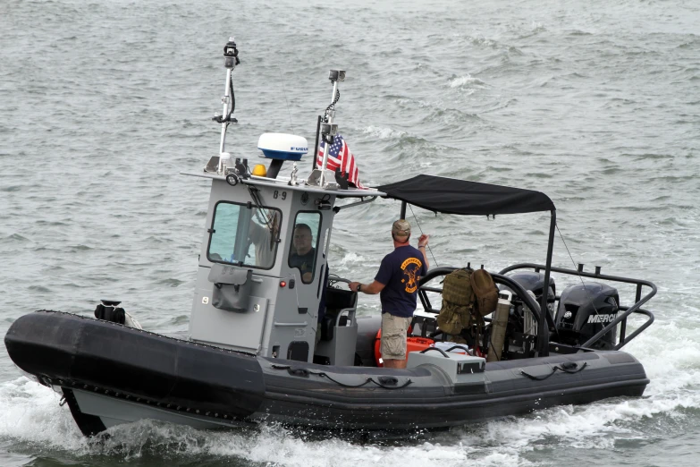 an inflatable motorboat makes its way across a body of water