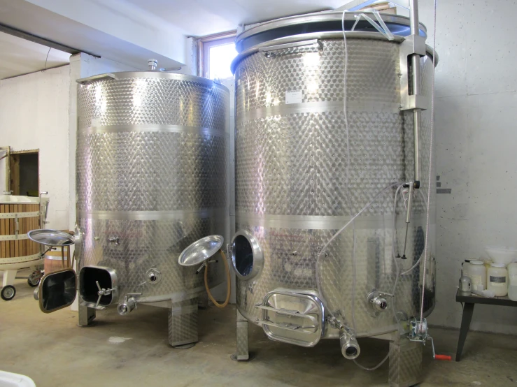 two large metal tanks sitting in the middle of a room