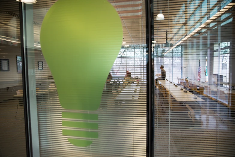 an office is reflected in the glass of windows