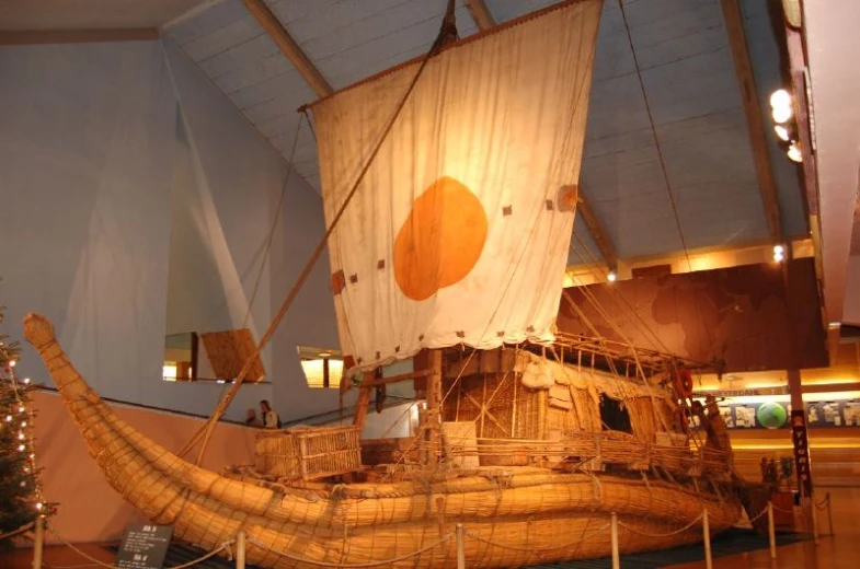 a boat shaped model is on display in a building